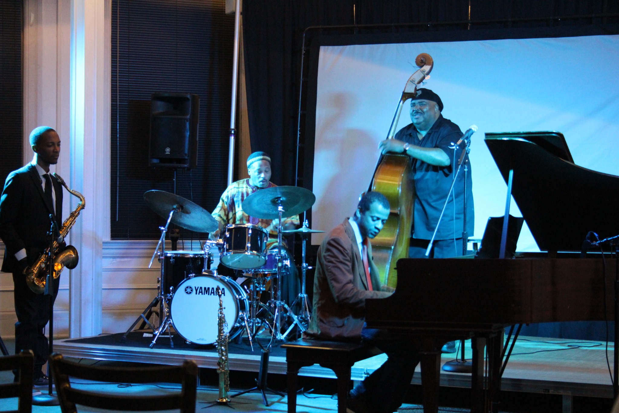 Jazz ensemble performing at the Jazz Network Foundation 22nd anniversary, with saxophone, drums, piano, and upright bass