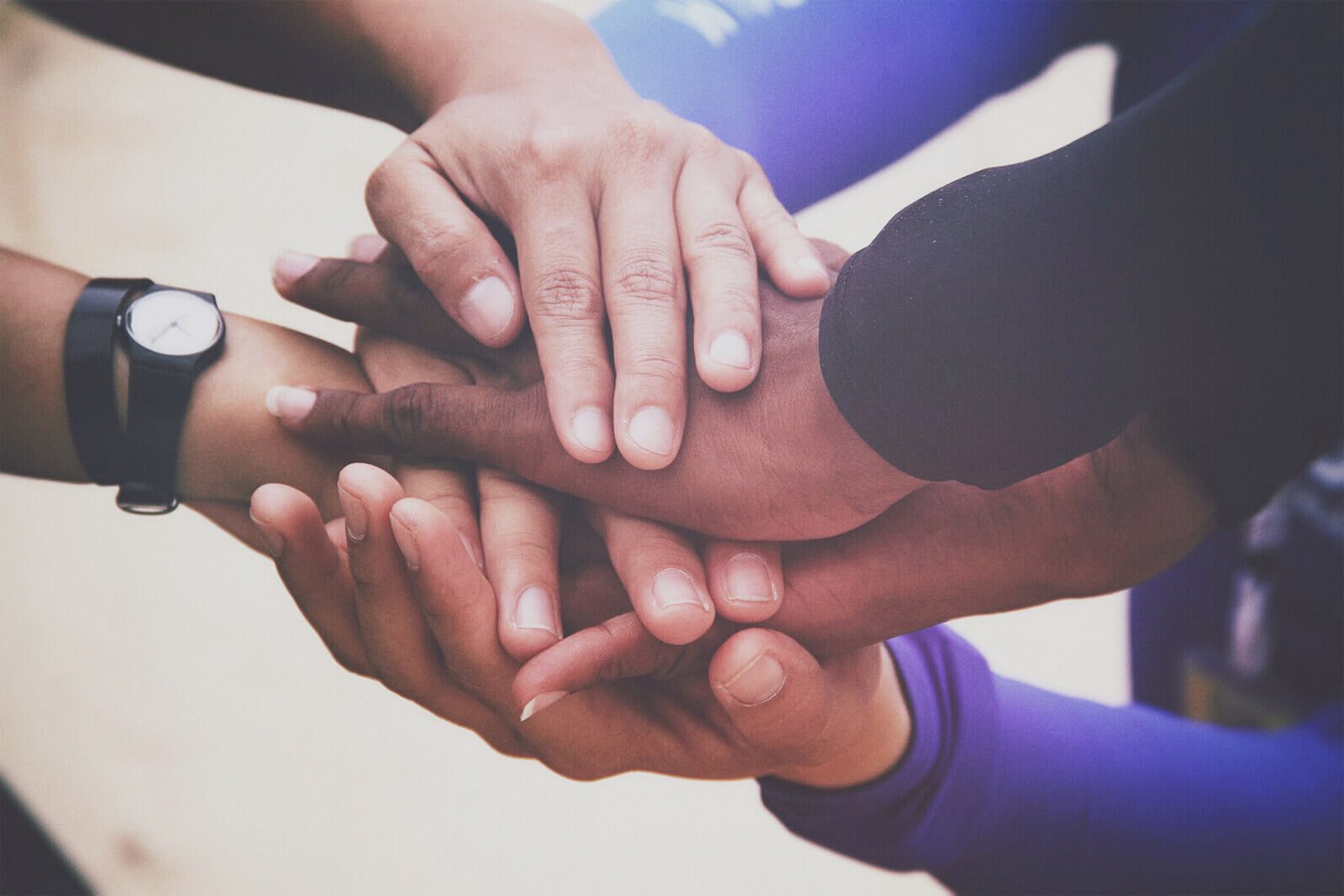 Hands joined in collective support