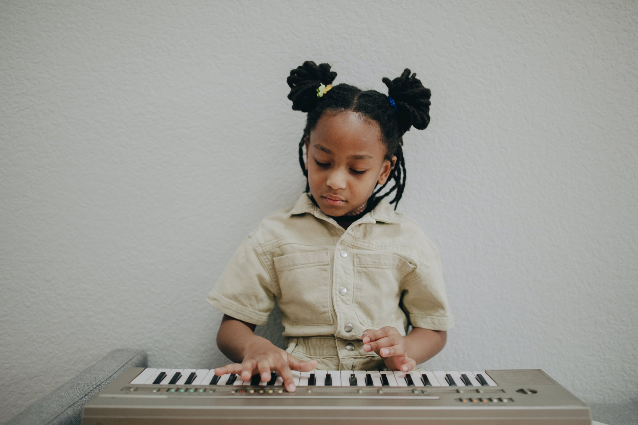 A young child learning keyboard